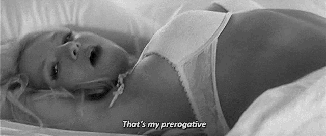 a woman in lingerie is laying on a bed and says that 's my prerogative .