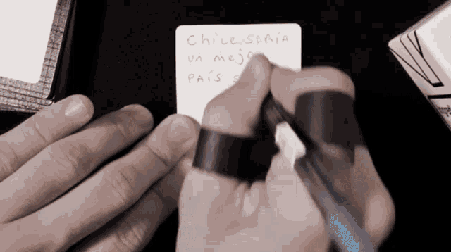 a person is writing on a piece of paper that says chile scala on it
