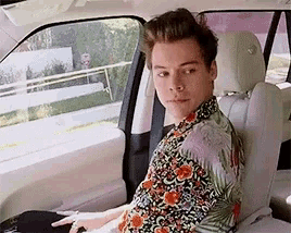 a man is sitting in the back seat of a car .
