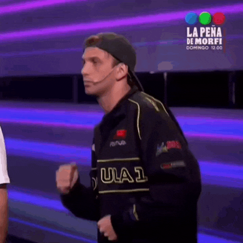 a man wearing a jacket that says ula1 is dancing