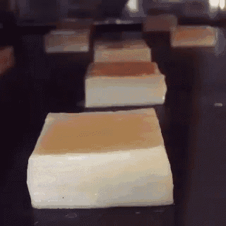 a bunch of squares of butter are lined up on a table