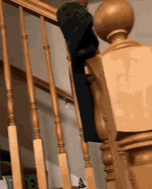 a person standing on a wooden staircase with a black shirt on