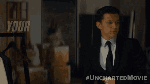 a man in a suit and tie stands in front of a sign that says your life seemed super sad