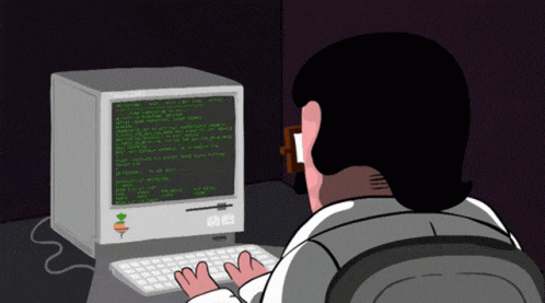 a man is typing on a keyboard in front of a computer that says apple on it