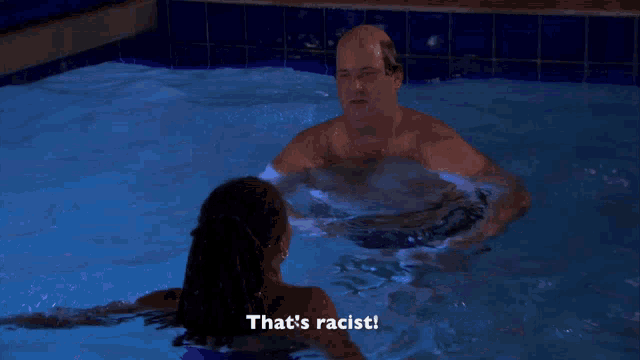 a man in a swimming pool with the words that 's racist on the bottom