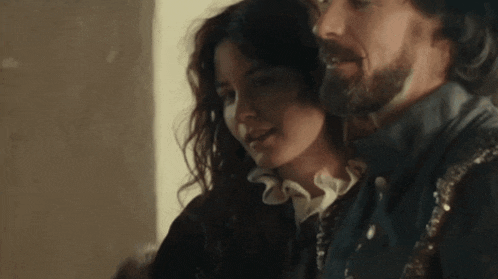 a man and woman are standing next to each other