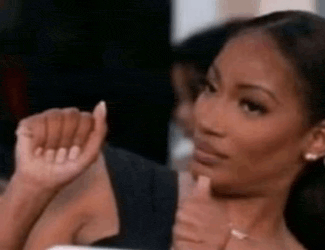 a woman is making a funny face while holding her hand to her face .