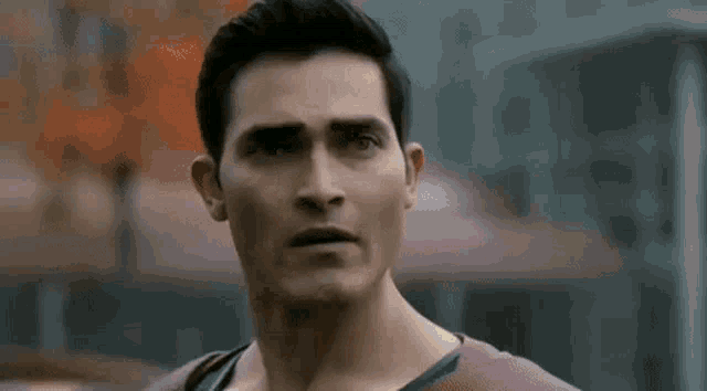 a close up of a man 's face with a serious look on his face and a blurred background .