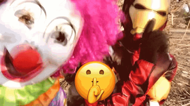 a clown and a man in an iron man costume pose for a photo