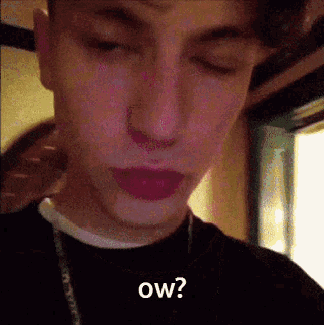 a close up of a person 's face with the words " ow " written on it