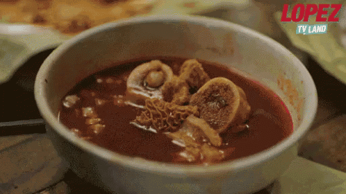 a close up of a bowl of soup with the word lopez on the bottom