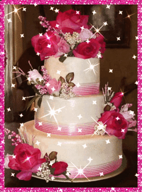 a three tiered cake with pink flowers and ribbons