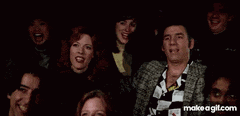 a group of people are posing for a picture in a dark room with the words make a gif.com on the bottom