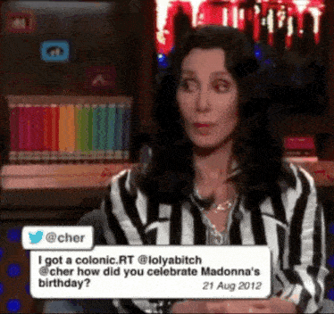 a woman in a striped shirt is asking cher how she celebrated madonna 's birthday