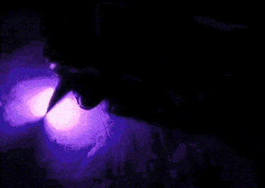 a pixelated image of a person with a purple light coming out of their mouth