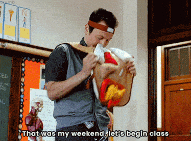 a man in a classroom with a headband on says " that was my weekend "