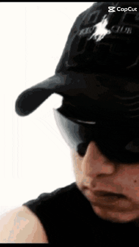a man wearing a polo club hat and sunglasses looks down