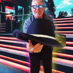 a man wearing sunglasses is holding a large fish