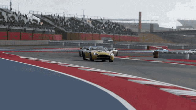a yellow sports car is on a race track
