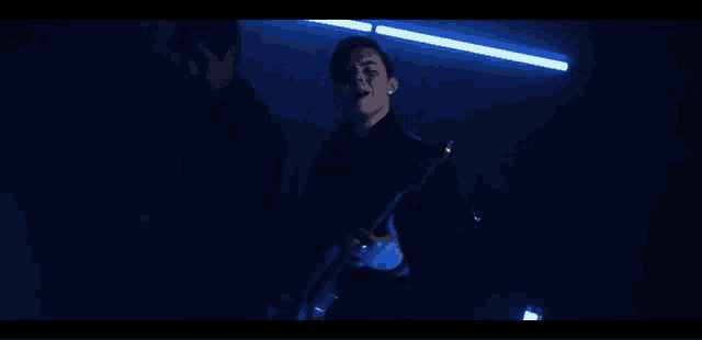 a man is singing while another man plays a guitar