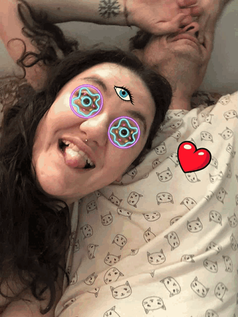 a man and a woman with glowing eyes and a heart on their shirt