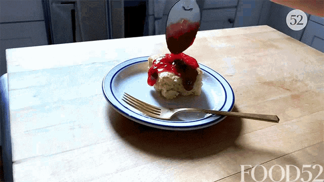 a piece of cake on a plate with a fork and the number 52 on the bottom