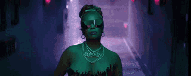 a woman wearing sunglasses and a necklace with the word austin on it .