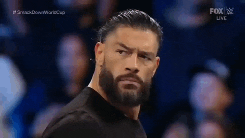 roman reigns is a wrestler with a beard and mustache .