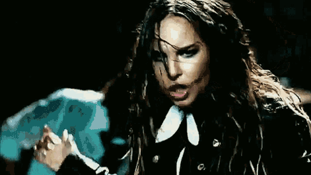 a close up of a woman 's face with a saxophone in the background .