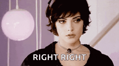 a woman with short hair and a choker is standing in front of a pink ball and says right right .