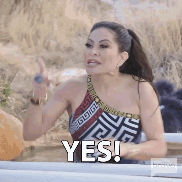 a woman in a bathing suit says yes in front of pumpkins