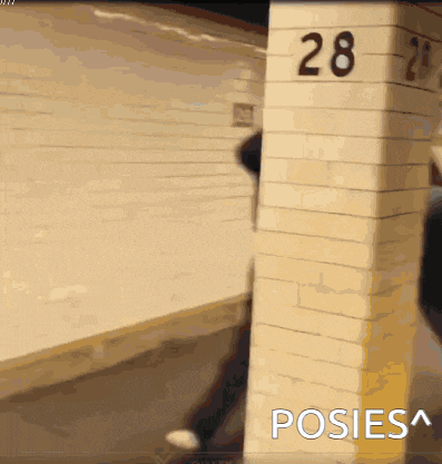 a brick pillar with the number 28 written on it