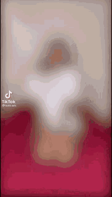 a blurred image of a person on a pink background with a tiktok watermark