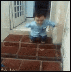 a baby is walking down a set of stairs