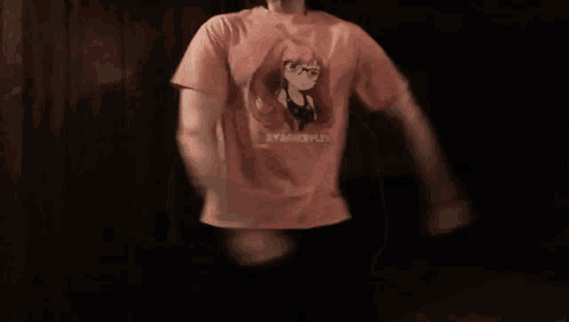 a person wearing a pink t-shirt with a girl on it