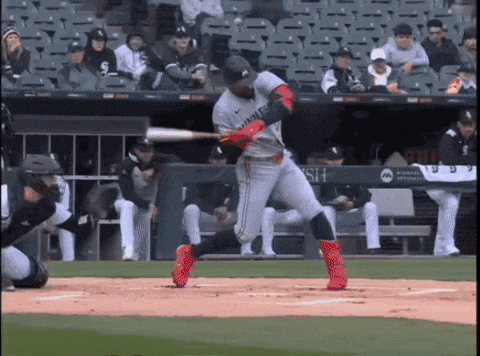 a baseball player swings his bat at a pitch in front of a banner that says hsn
