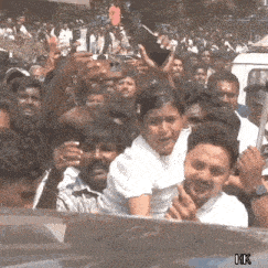 a group of people are gathered in a crowd with hk written on the bottom