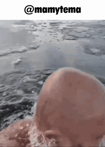 a baby swimming in a body of water with a caption that says mamytema