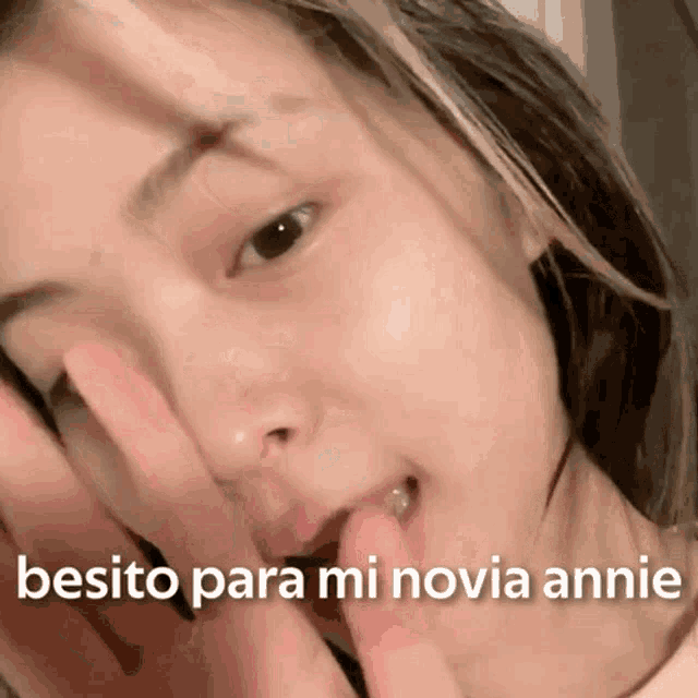 a close up of a woman 's face with the words besito para mi novia annie written on the bottom