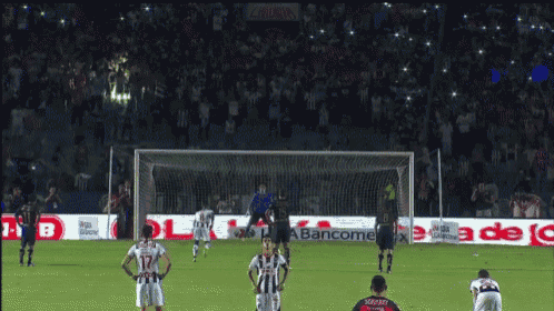 a soccer game is being played in front of a banner that says bancomer.mx