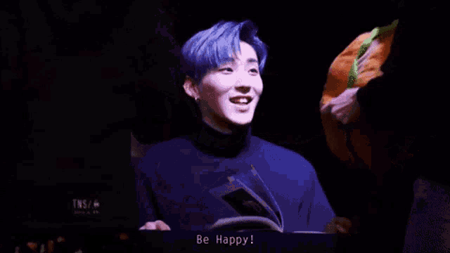 a person is holding a stuffed hamburger that says " be happy "