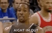 a basketball player is sitting in the stands watching a game and making a funny face .