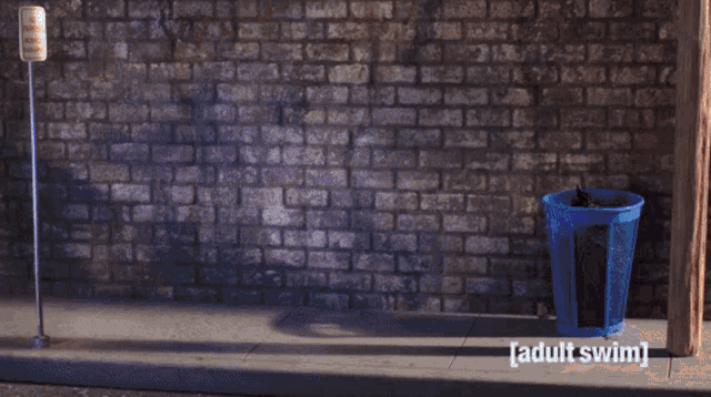 a blue trash can next to a brick wall with the words adult swim on the bottom