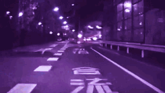 a blurry picture of a street with a purple background and the letter l