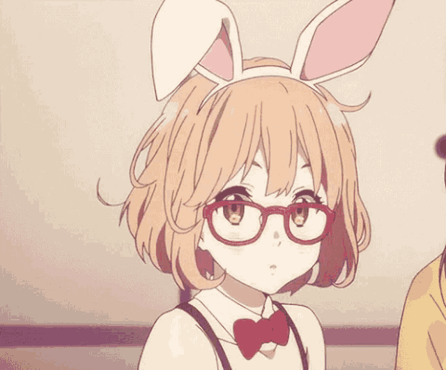 a girl wearing bunny ears and glasses is standing next to a boy .