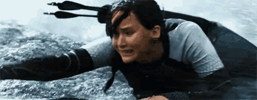 a woman is swimming in the water with three arrows in her head .