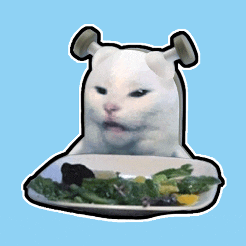 a cat with shrek ears is eating a salad on a plate