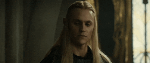 a man with long blonde hair and a caption that says captivating on it