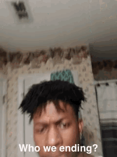 a man with dreadlocks is looking at the camera with the words who we ending below him