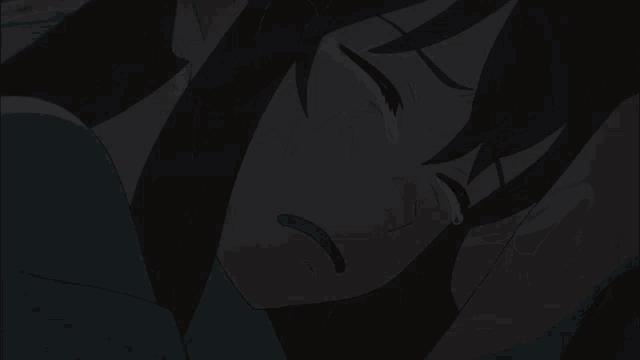 a woman covering her face with her hands in the dark